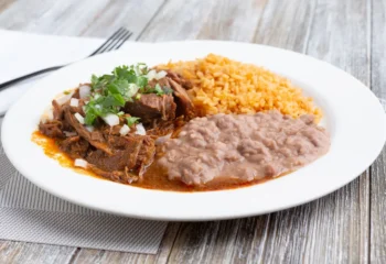 #107  Birria Fiesta Plate with Spanish Rice, Refried Beans, and Mexican Street Corn